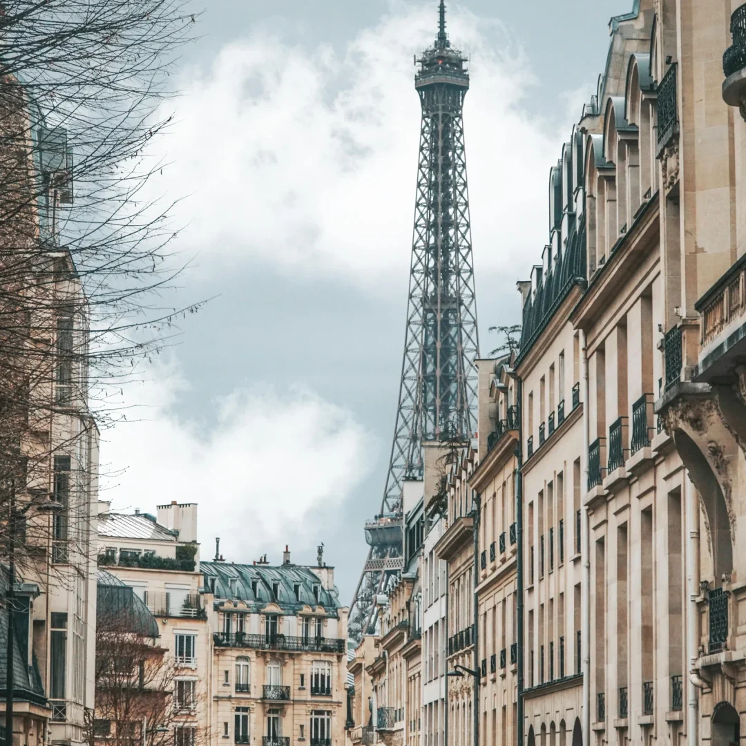 Quaint Parisian street with the Eiffel Tower in the background, showcasing iconic architecture.